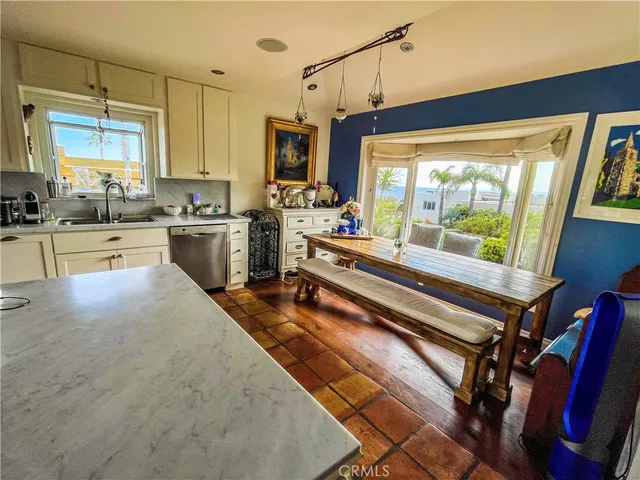 a kitchen with a large window appliances and cabinets