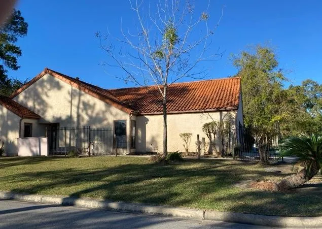 a view of an empty room with a fireplace and a window