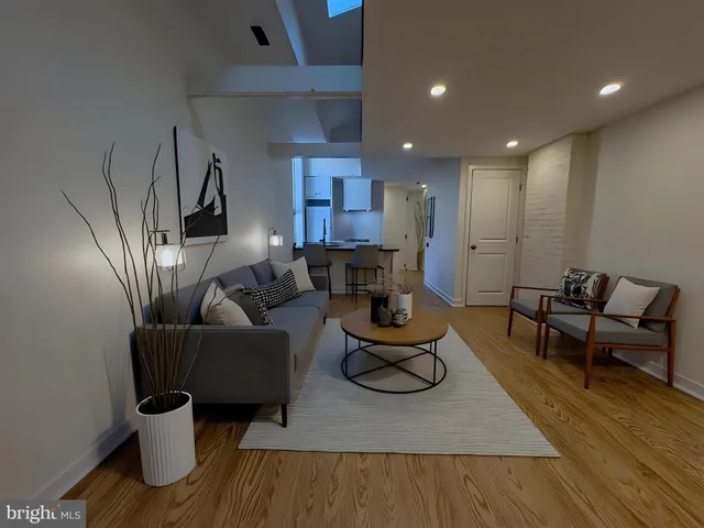 a large bed sitting in a bedroom next to a lamp