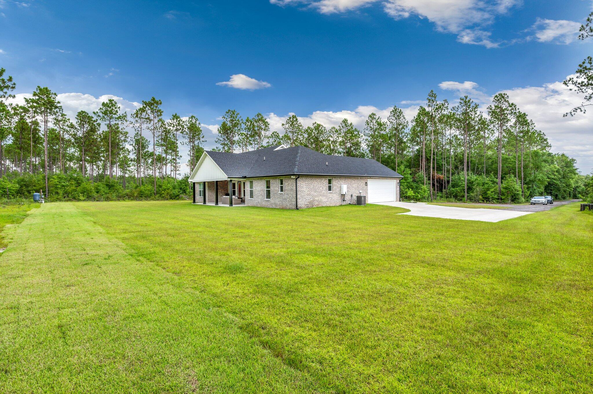 5736 Griffith Cemetery Road Baker, FL 32531 - Photo 54 of 56 a house view with swimming pool and garden space