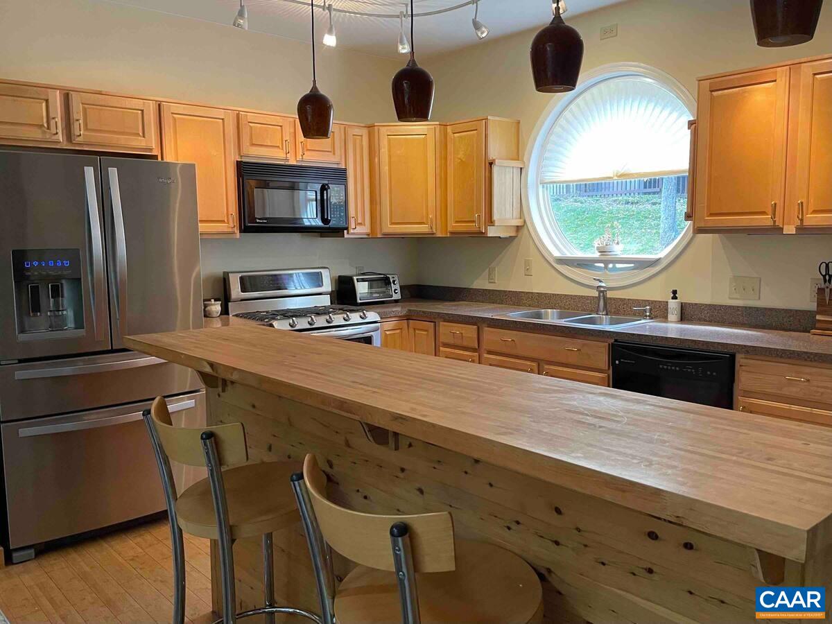 62 Summit Court Roseland, VA 22967 - Photo 11 of 75 a kitchen with stainless steel appliances granite countertop a stove a sink and a microwave