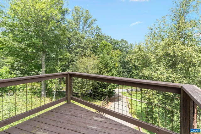 a bedroom with a bed flat screen tv and window