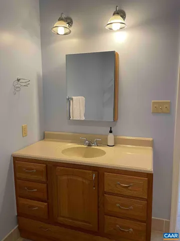 a view of a house with backyard and a tree