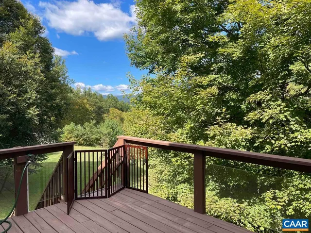a view of balcony with furniture and wooden deck