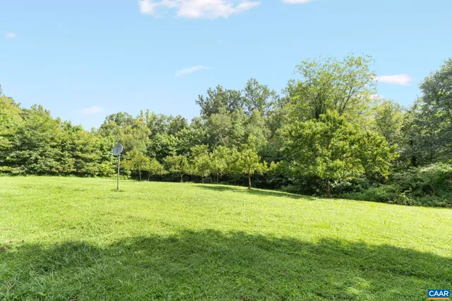 a view of a wooden deck with a yard