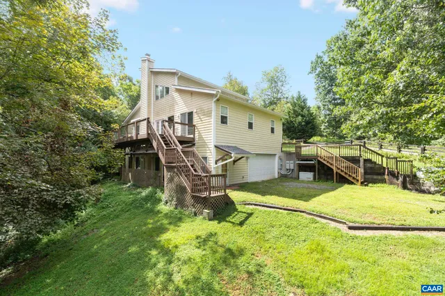 a big yard with lots of green space and deers