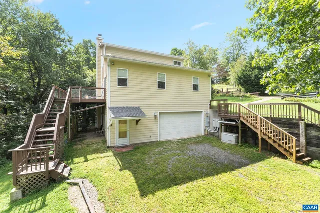 a view of a house with a yard and sitting area