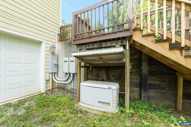 a view of a wooden deck and yard with green space