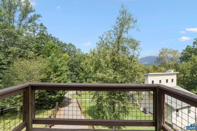a view of balcony with wooden floor and fence