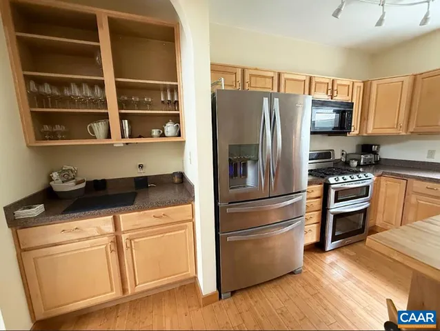 a kitchen with stainless steel appliances a stove a sink and a refrigerator