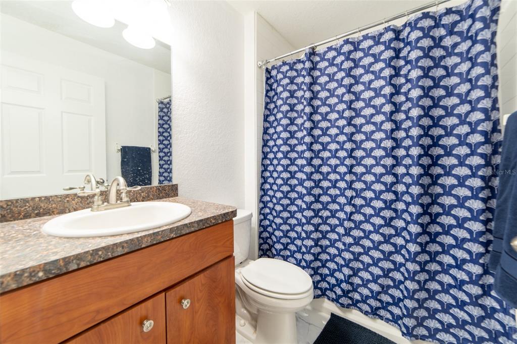 5107 Southwest 165th St Road Ocala, FL 34473 - Photo 21 of 34 a bathroom with a granite countertop toilet and a sink