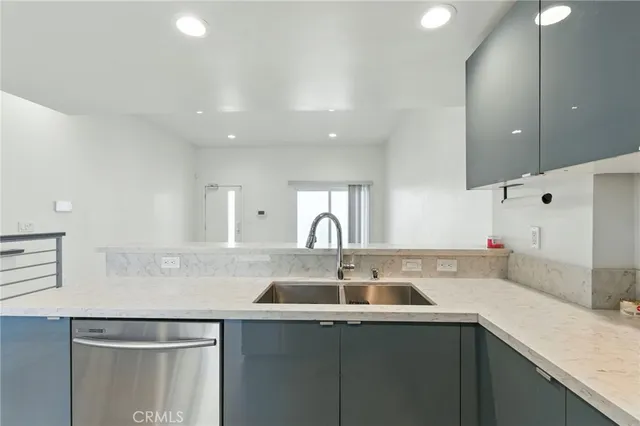 a kitchen with stainless steel appliances granite countertop a sink and a stove top oven