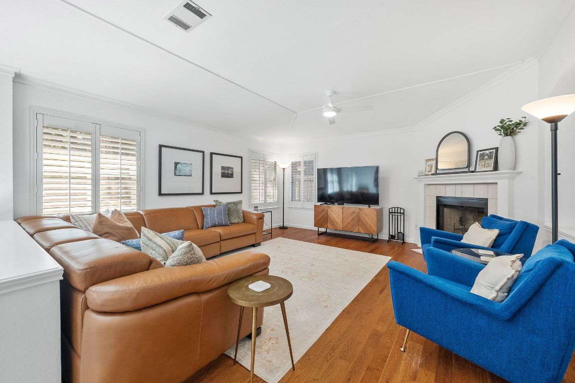 a living room with furniture a fireplace and a flat screen tv