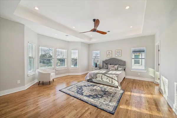 a bed room with a bed a window and a rug