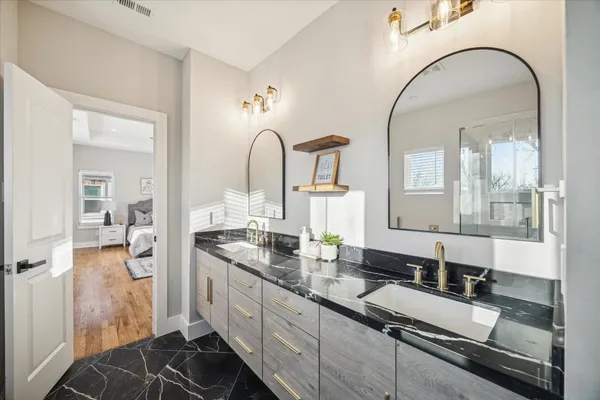 a white bath tub sitting next to a shower