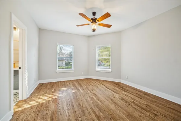 a view of a bedroom with a chandelier and wooden floor