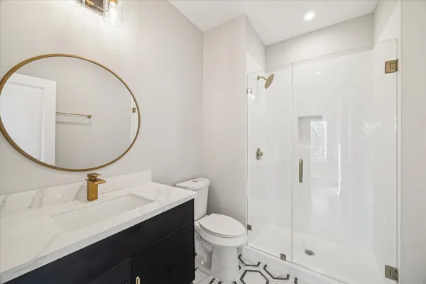 a bathroom with a sink toilet and shower
