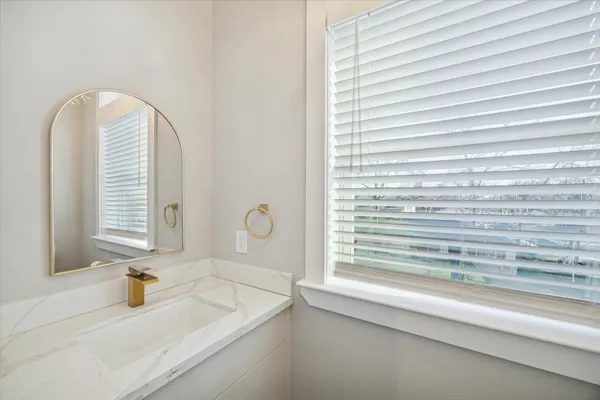 a bathroom with a sink and a window