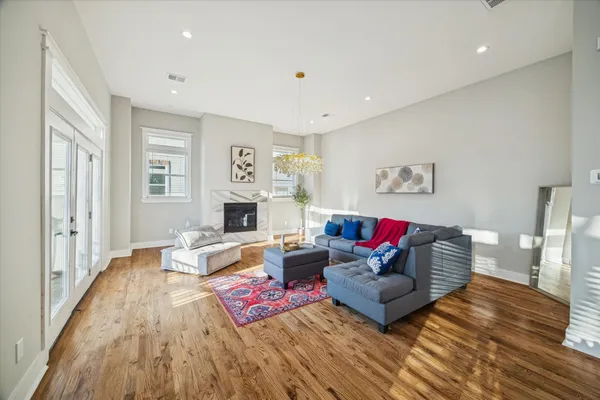 a living room with furniture and a wooden floor
