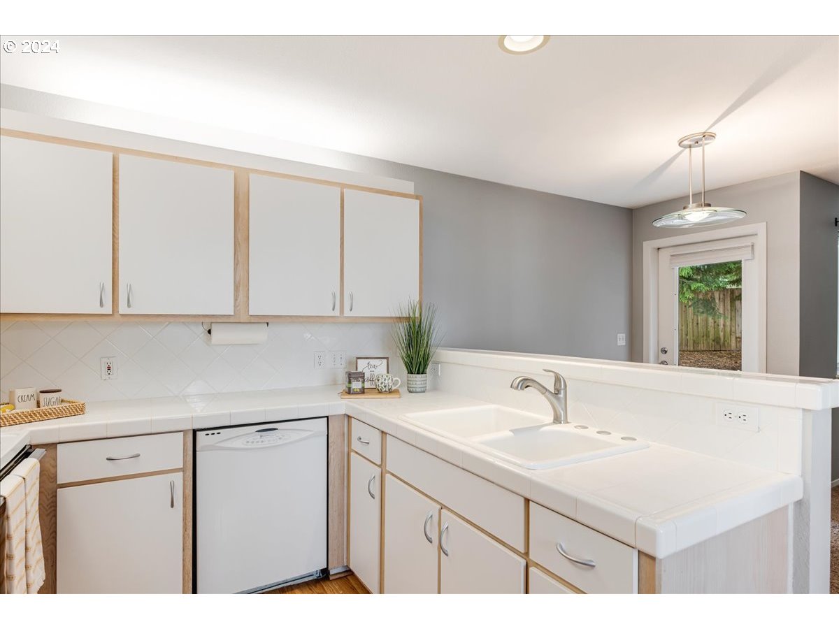 5225 Jean Road, Unit 313 Lake Oswego, OR 97035 - Photo 12 of 32 a kitchen with a sink cabinets and a window