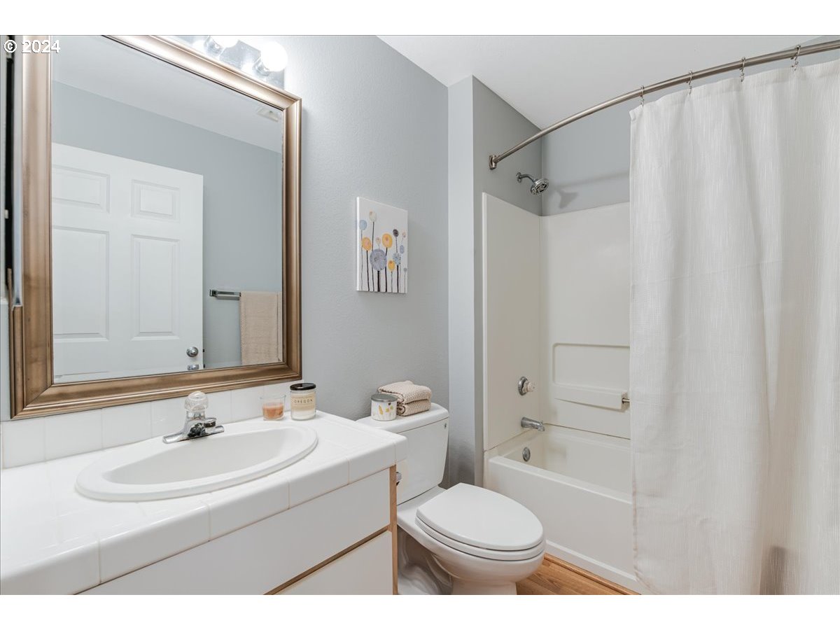 5225 Jean Road, Unit 313 Lake Oswego, OR 97035 - Photo 22 of 32 a bathroom with a sink toilet a mirror and shower