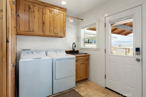 a bedroom with a bed and a table in it with wooden floor
