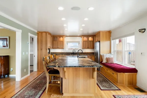 a kitchen with granite countertop a sink stove and refrigerator