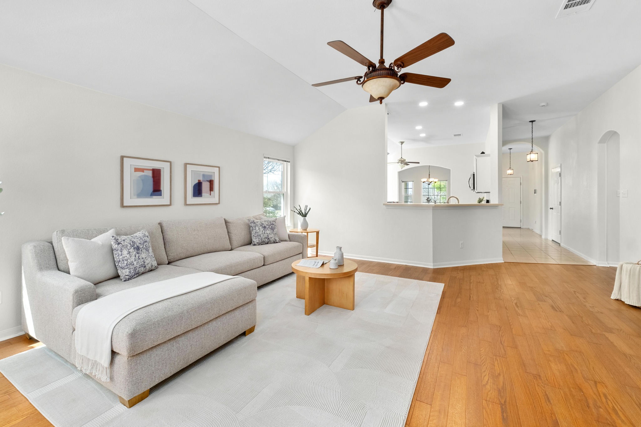 100 Pecanwood South Kyle, TX 78640 - Photo 13 of 35 The wraparound breakfast bar connects the living room to the kitchen, allowing conversations to carry easily between the two spaces while keeping the living area open and inviting