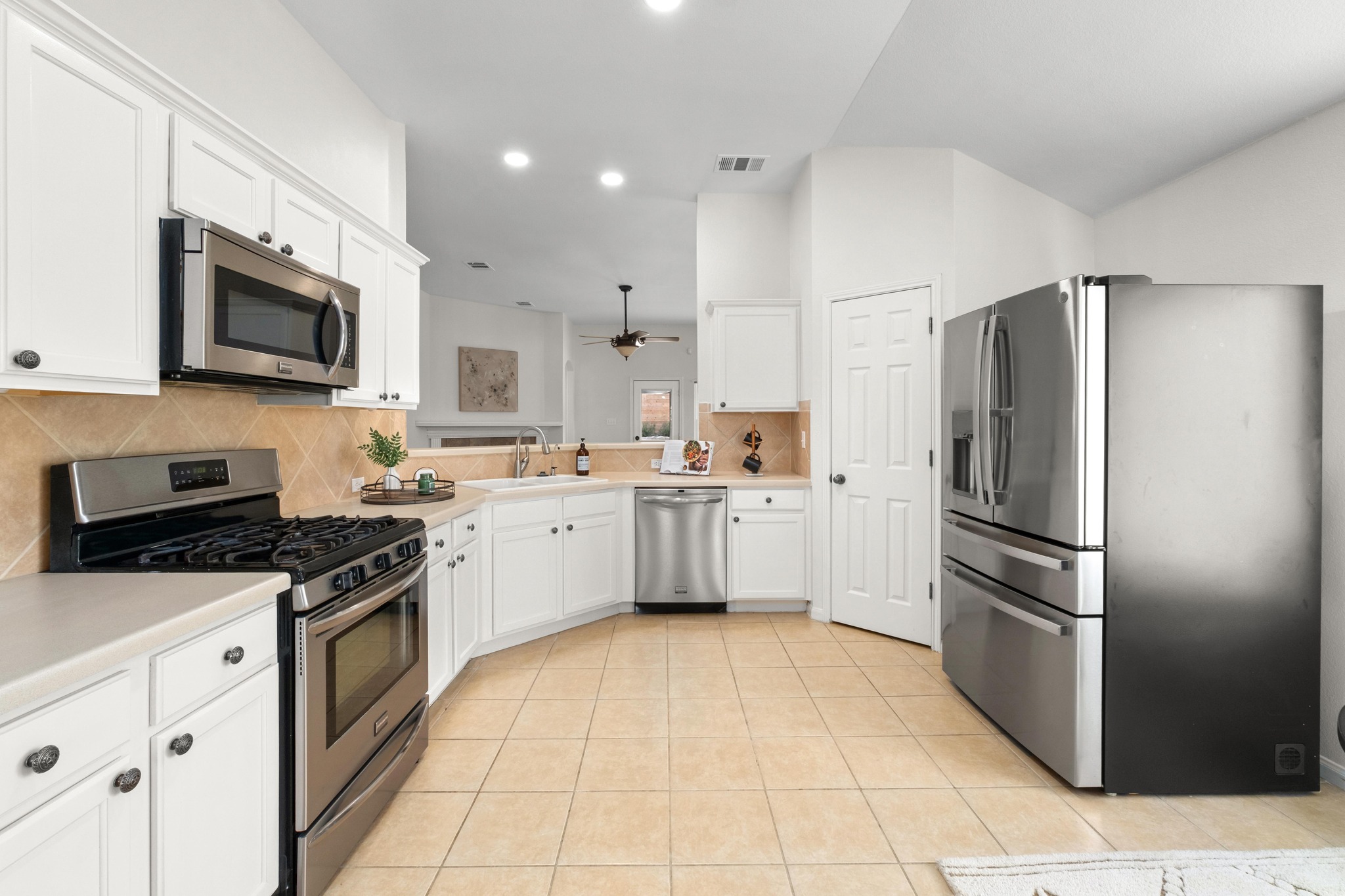 100 Pecanwood South Kyle, TX 78640 - Photo 2 of 35 The kitchen is designed with a layout that keeps everything within reach, offering stainless steel appliances, generous cabinetry, and plenty of storage for everyday cooking