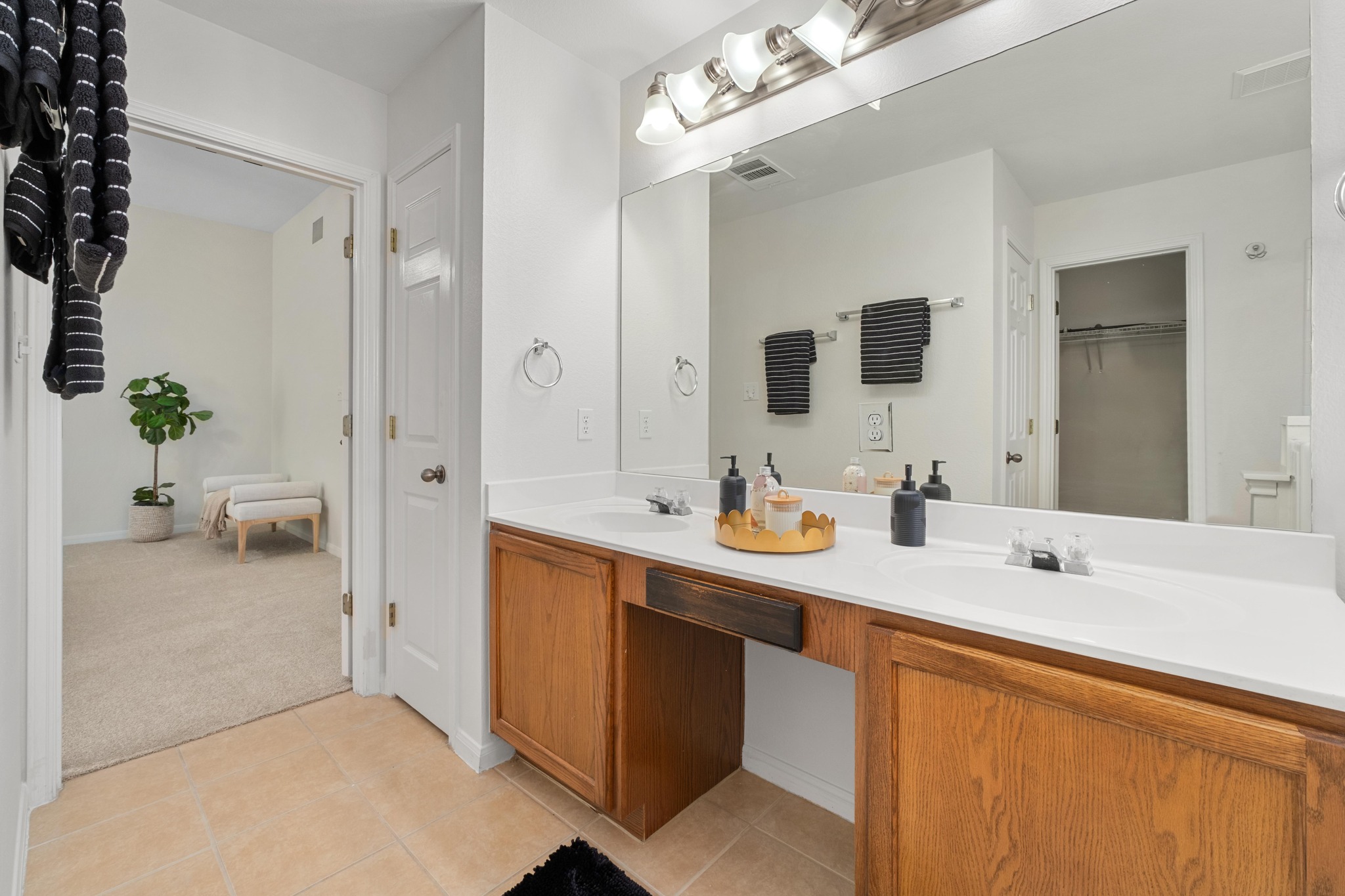 100 Pecanwood South Kyle, TX 78640 - Photo 21 of 35 The layout of the bathroom keeps everything comfortably arranged, with the vanity, tub, and separate shower all easily accessible before continuing into the walk-in closet