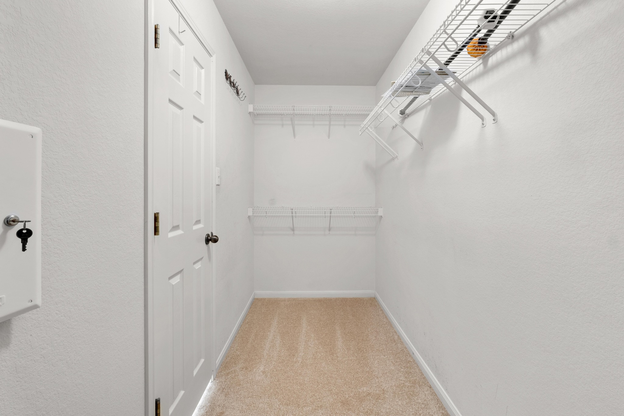 100 Pecanwood South Kyle, TX 78640 - Photo 22 of 35 The walk-in closet sits just beyond the primary bathroom, offering a spacious storage area with room to keep clothing, shoes, and everyday essentials organized and within easy reach