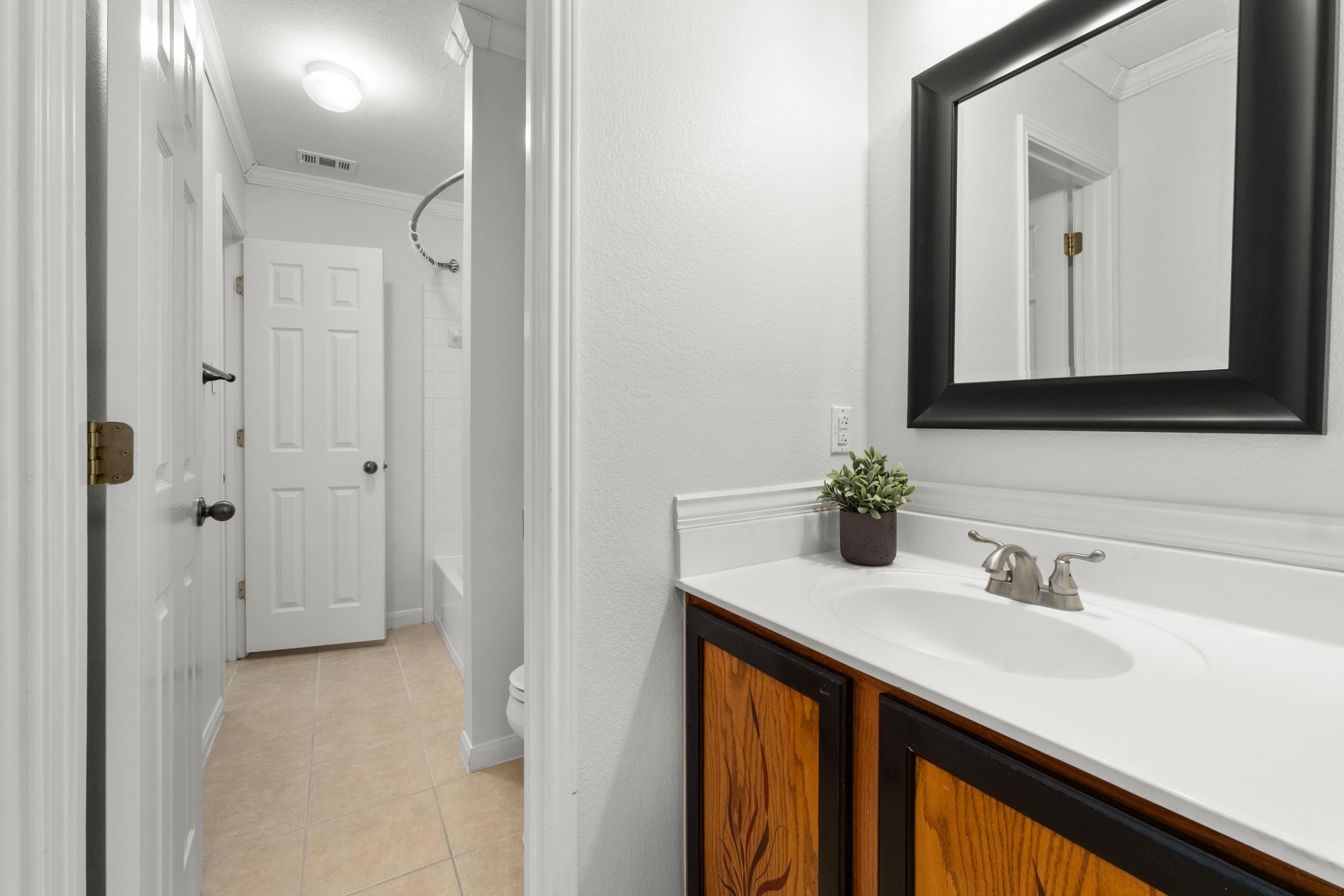 100 Pecanwood South Kyle, TX 78640 - Photo 25 of 35 The guest bathroom is centrally located between the secondary bedrooms, making it easily accessible for both guests and daily use