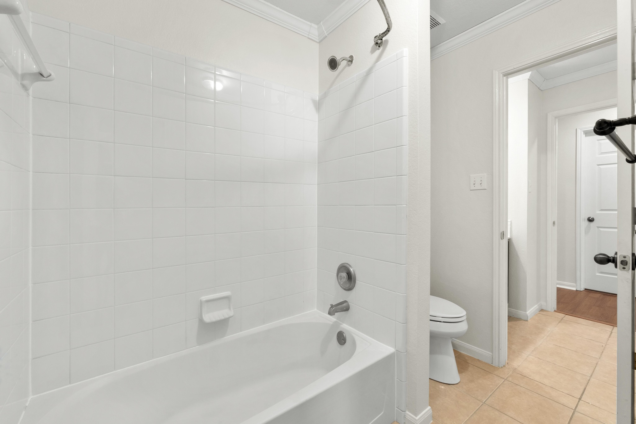 100 Pecanwood South Kyle, TX 78640 - Photo 26 of 35 The bathroom is designed with a practical layout that keeps the vanity and bathing area easy to navigate for multiple users throughout the day