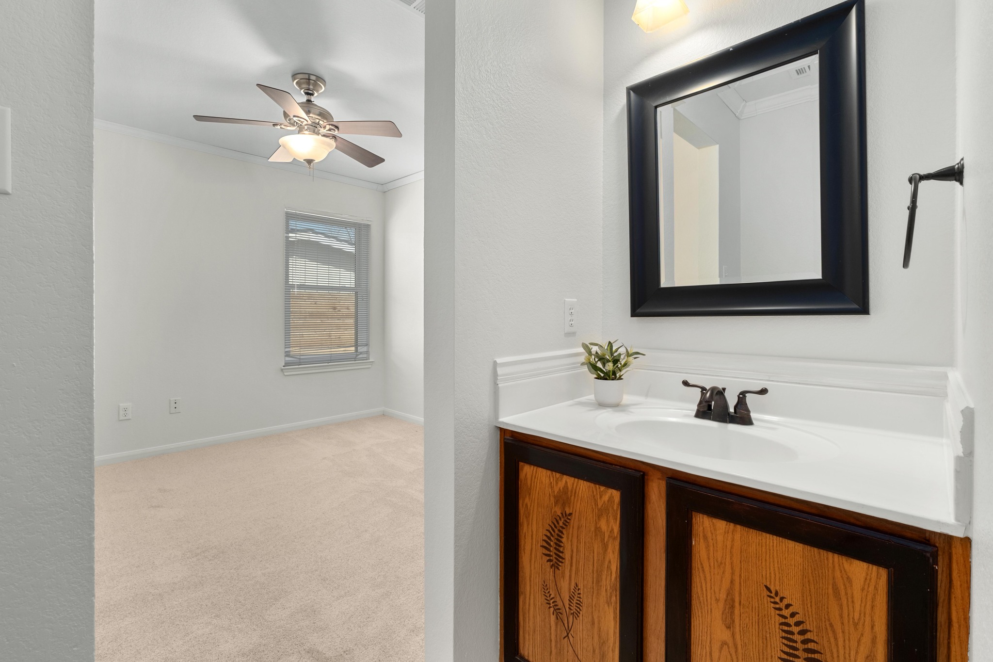 100 Pecanwood South Kyle, TX 78640 - Photo 27 of 35 One of the guest bedrooms includes its own vanity area with direct access to the full bathroom, creating a convenient setup for guests or everyday routines