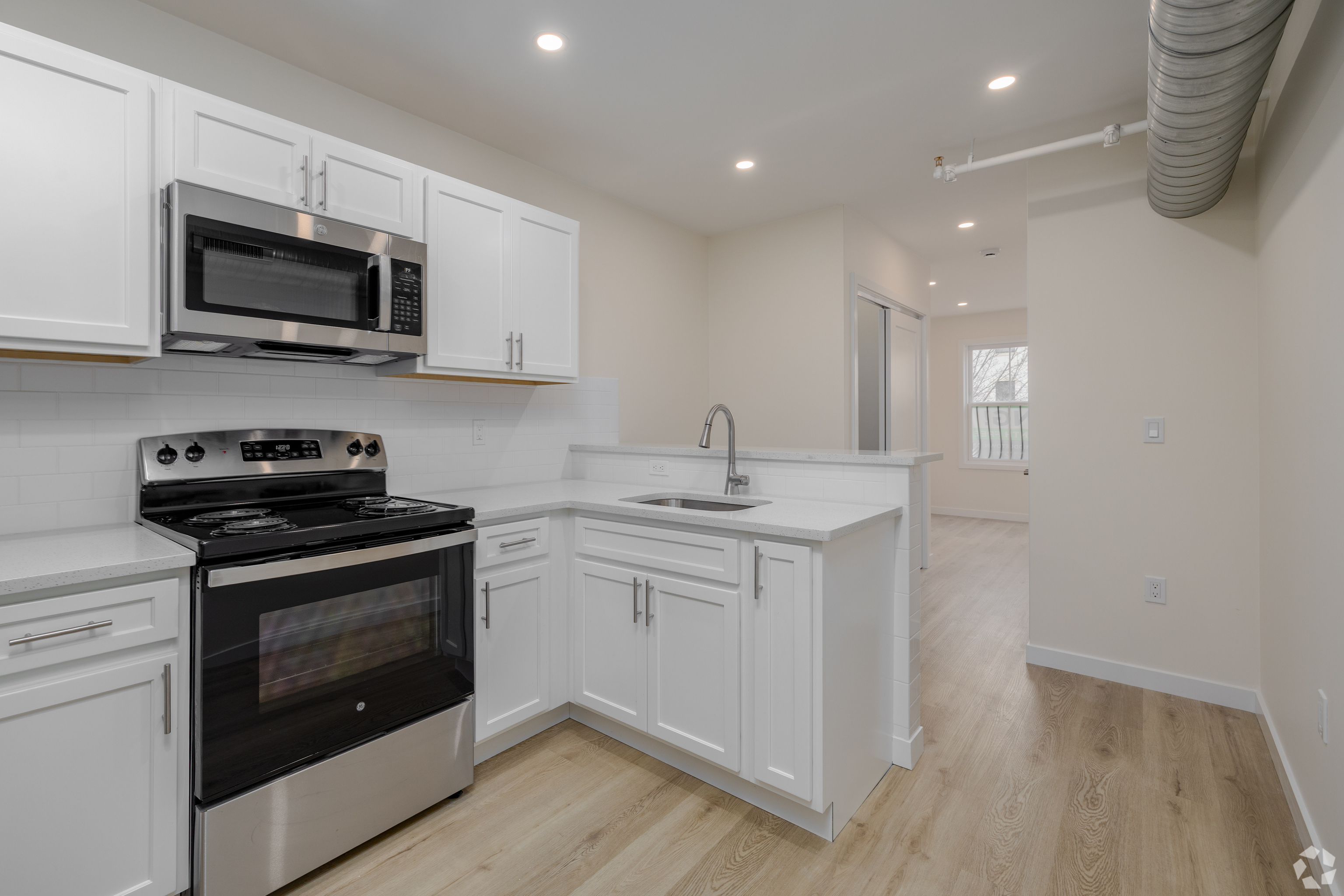 584 Main Street, Unit H Middletown, CT 06457 - Photo 1 of 10 a kitchen with stainless steel appliances granite countertop a sink a stove a microwave and wooden cabinets