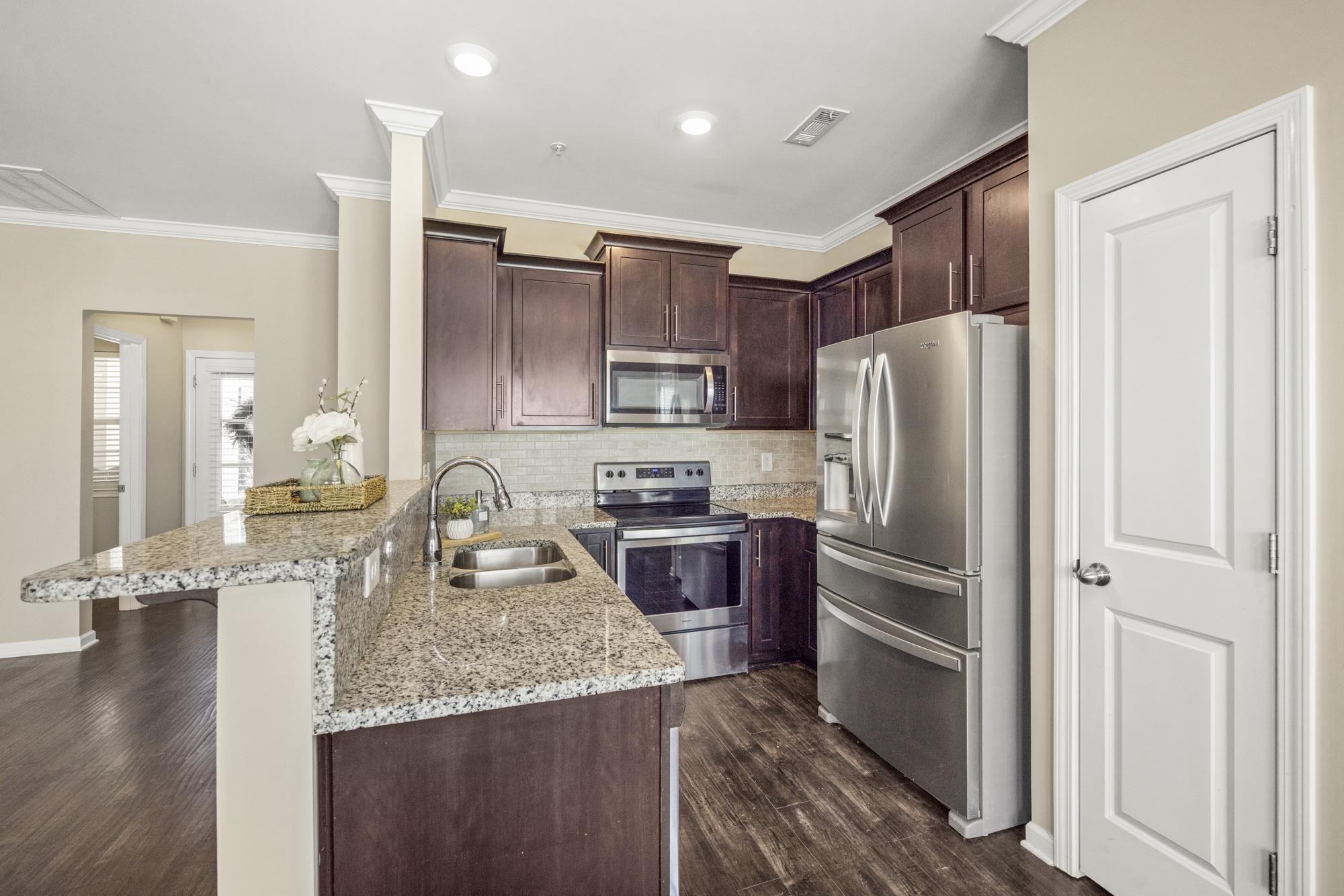 112 Bergen Drive Spring Hill, TN 37174 - Photo 18 of 37 a kitchen with granite countertop stainless steel appliances and wooden cabinets