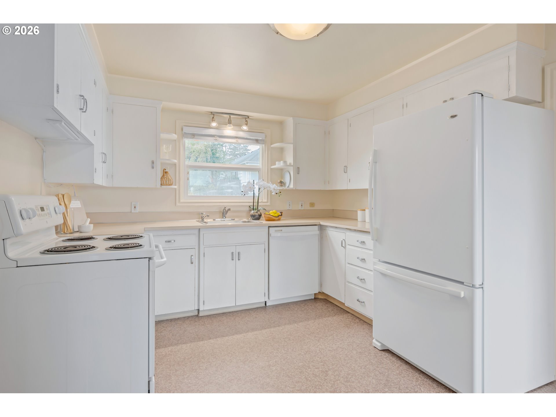 2031 Olive Street Eugene, OR 97405 - Photo 6 of 38 a kitchen with white cabinets and white appliances