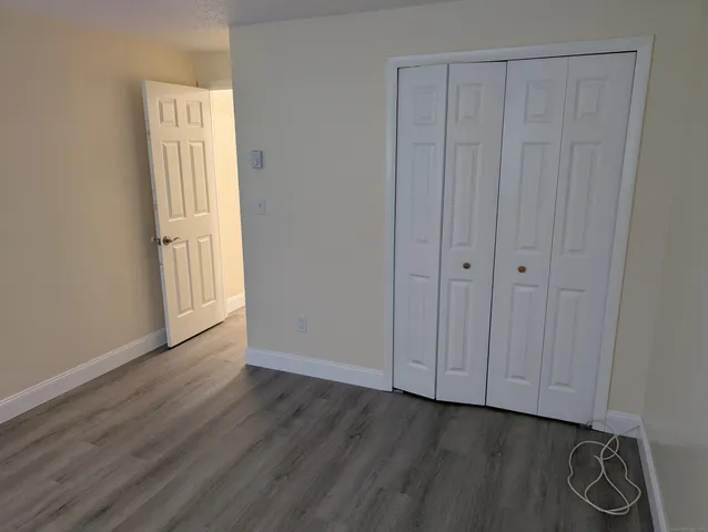 a view of an entryway with wooden floor