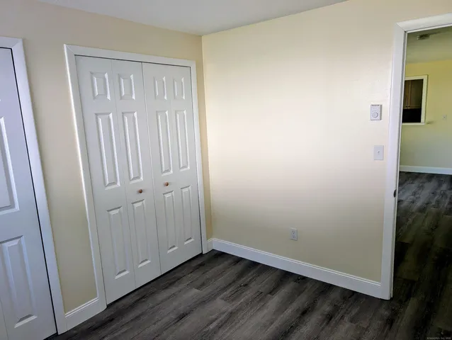 an empty room with wooden floor