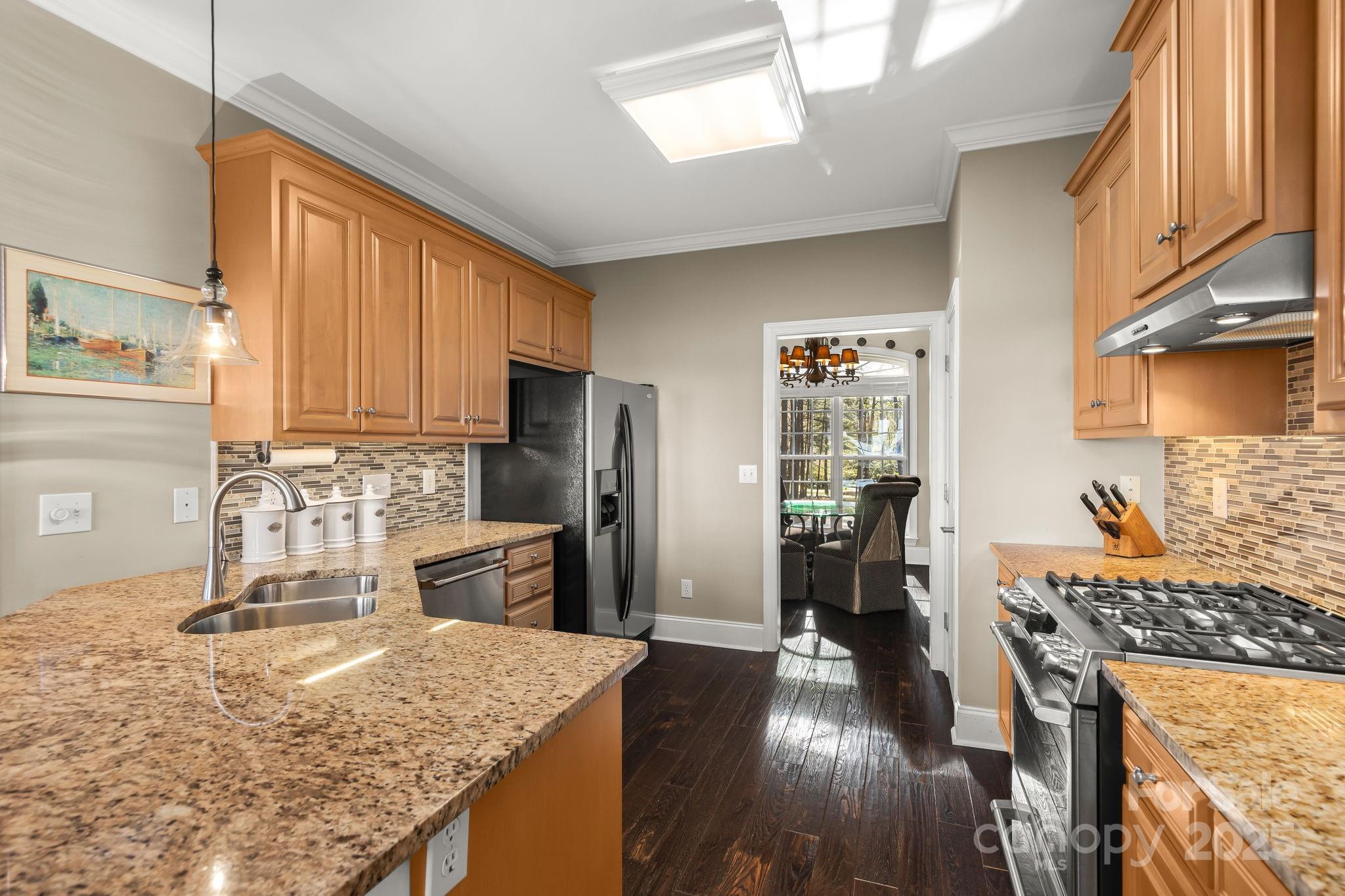 796 Lake Mist Drive Stanley, NC 28164 - Photo 11 of 43 a kitchen with stainless steel appliances granite countertop sink stove top oven and cabinets