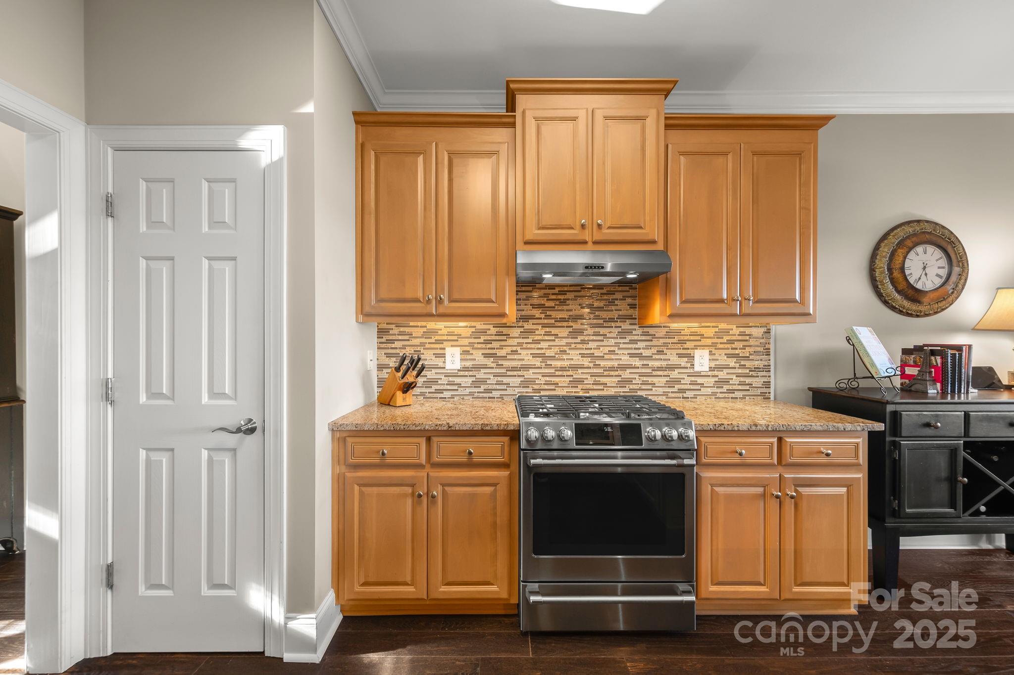 796 Lake Mist Drive Stanley, NC 28164 - Photo 13 of 43 a kitchen with granite countertop a stove and a sink