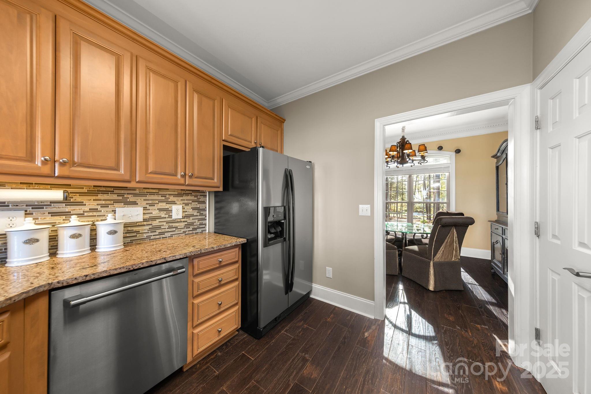 796 Lake Mist Drive Stanley, NC 28164 - Photo 14 of 43 a kitchen with a refrigerator stove and wooden cabinets