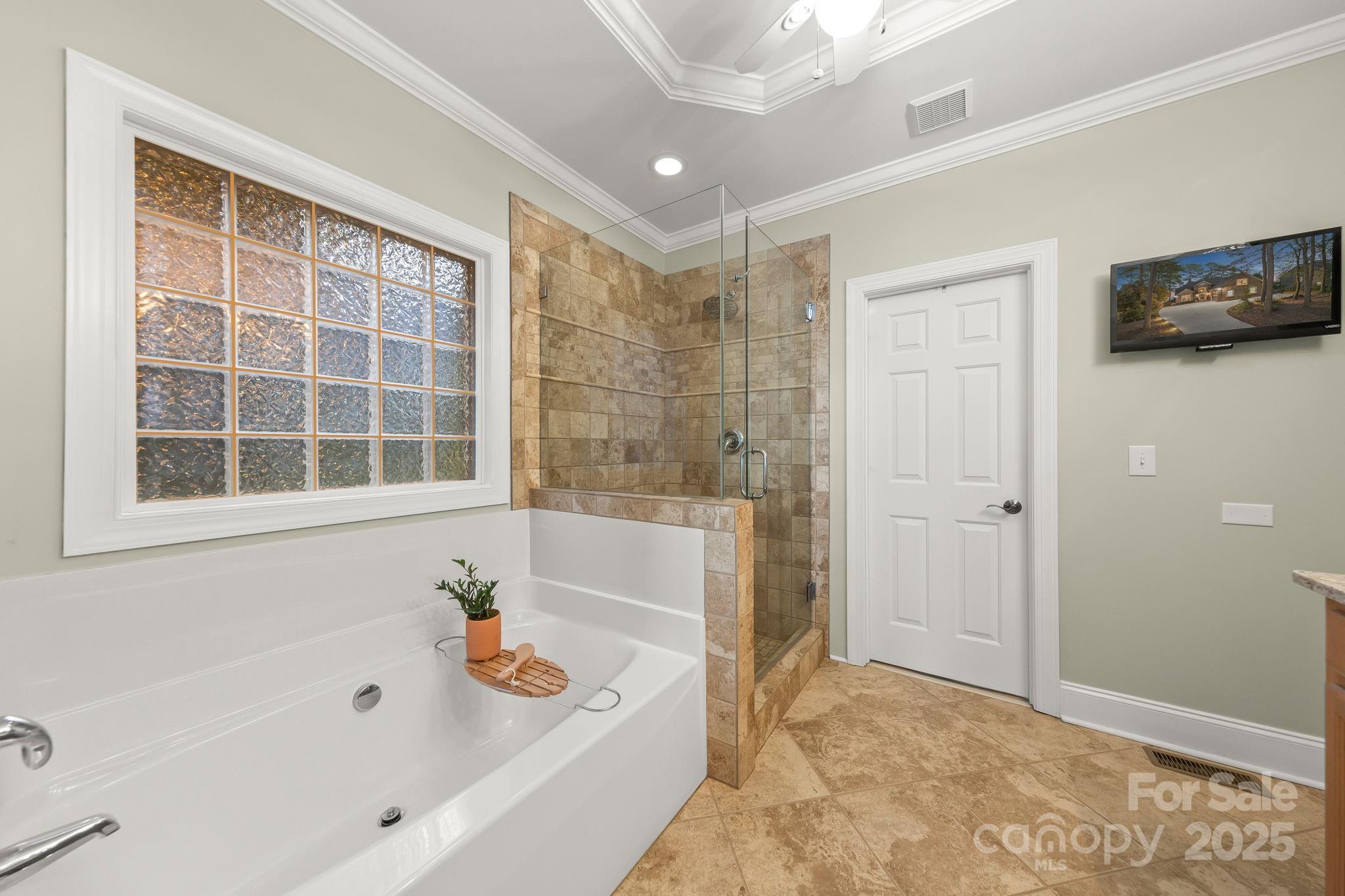 796 Lake Mist Drive Stanley, NC 28164 - Photo 19 of 43 a bathroom with a bathtub and a shower