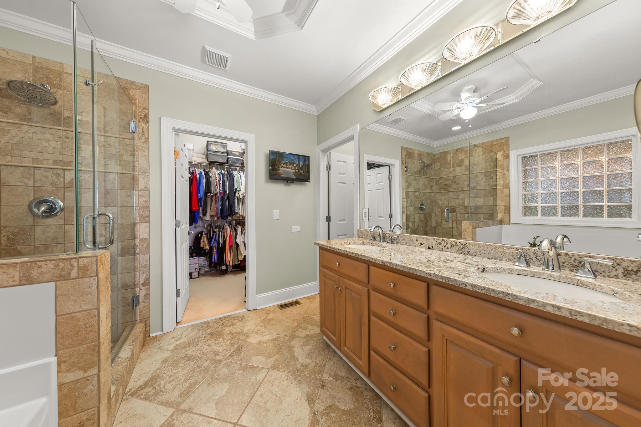 796 Lake Mist Drive Stanley, NC 28164 - Photo 20 of 43 a bathroom with a granite countertop sink mirror and shower