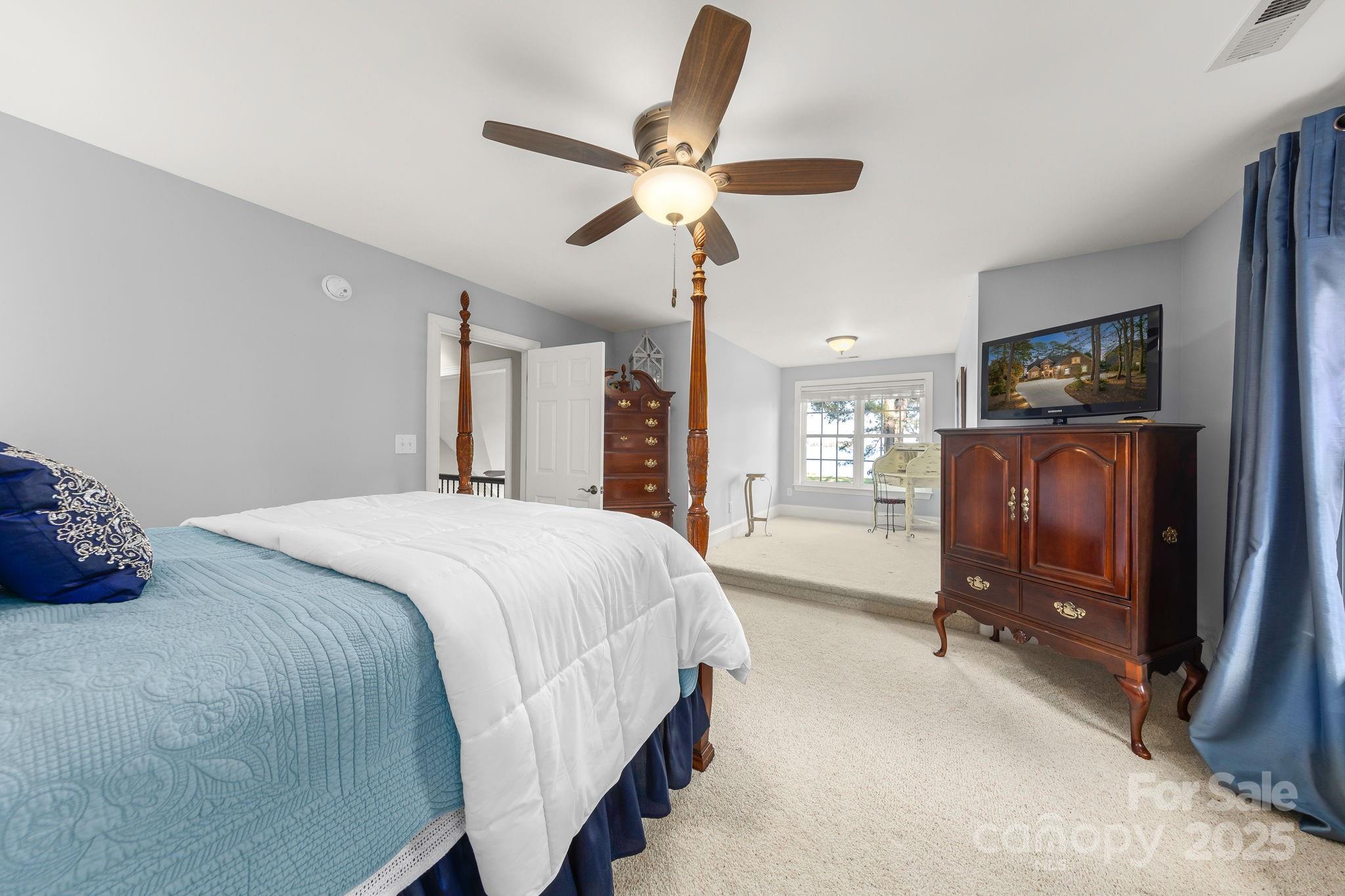 796 Lake Mist Drive Stanley, NC 28164 - Photo 26 of 43 a spacious bedroom with a bed and a flat screen tv