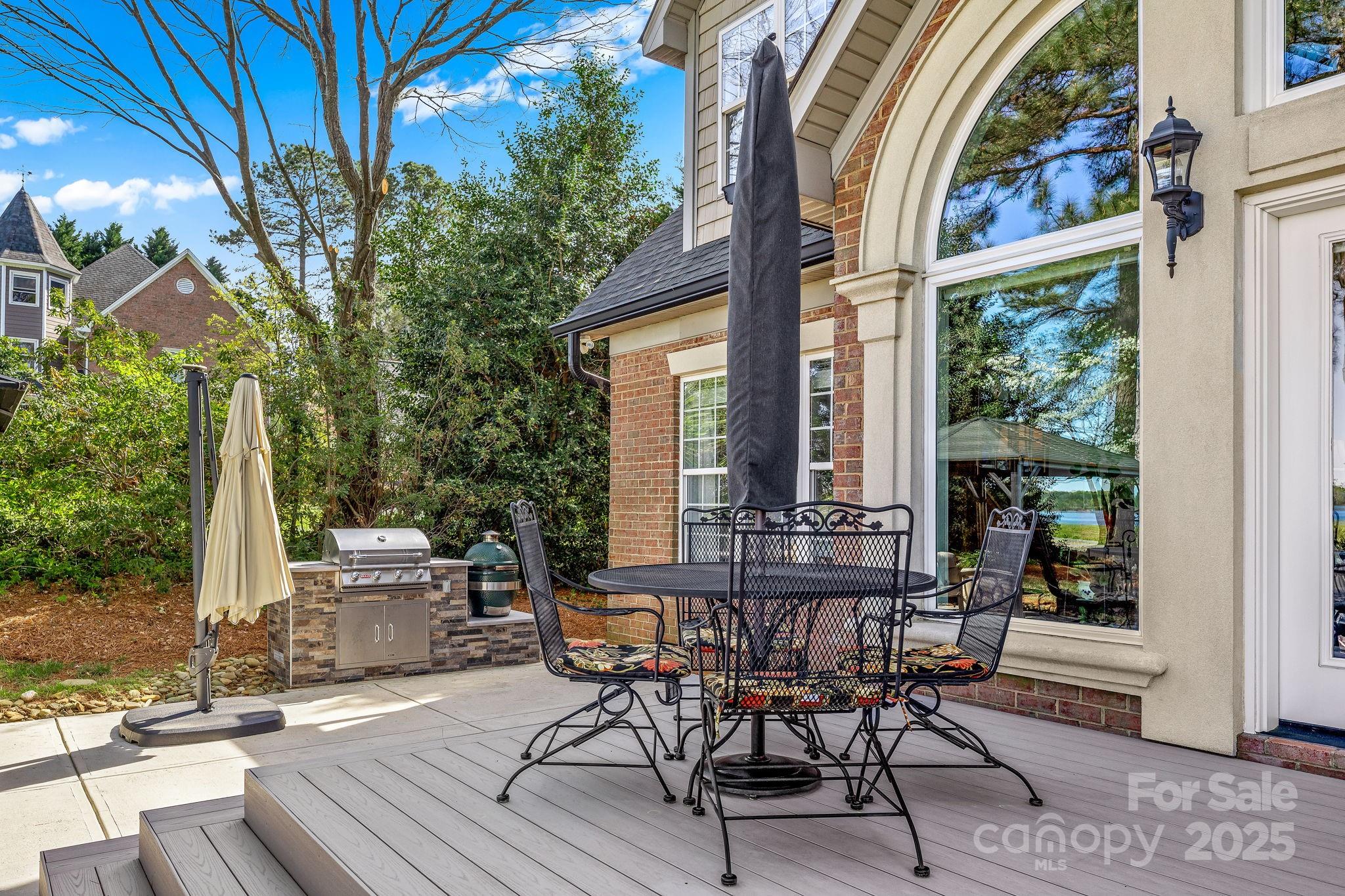 796 Lake Mist Drive Stanley, NC 28164 - Photo 39 of 43 a view of a patio with table and chairs and floor to ceiling window