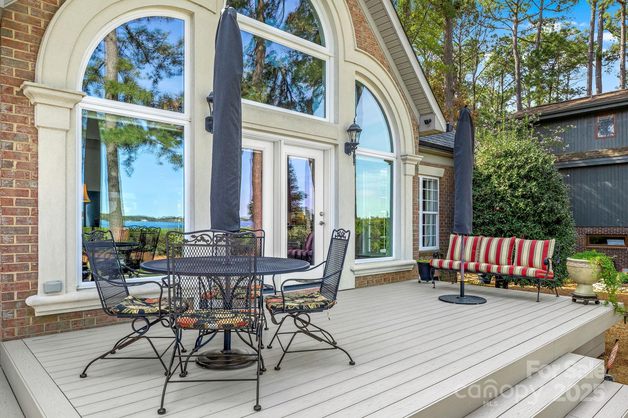 796 Lake Mist Drive Stanley, NC 28164 - Photo 40 of 43 a view of a patio with couches table and chairs and potted plants