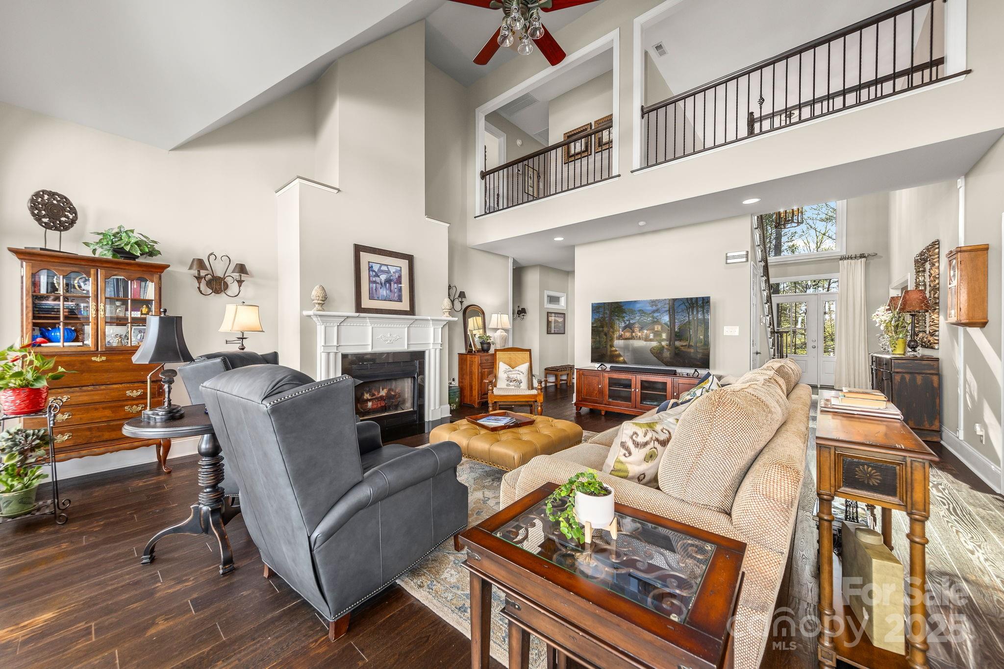 796 Lake Mist Drive Stanley, NC 28164 - Photo 8 of 43 a living room with furniture a flat screen tv and a fireplace