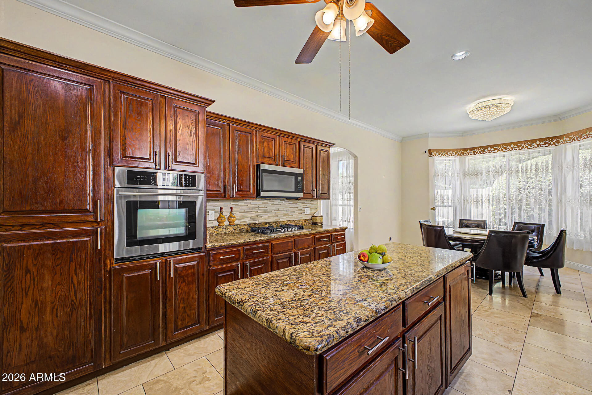 808 West Citrus Way Phoenix, AZ 85013 - Photo 12 of 35 a kitchen with stainless steel appliances granite countertop a stove top oven a sink dishwasher a dining table and chairs with wooden floor