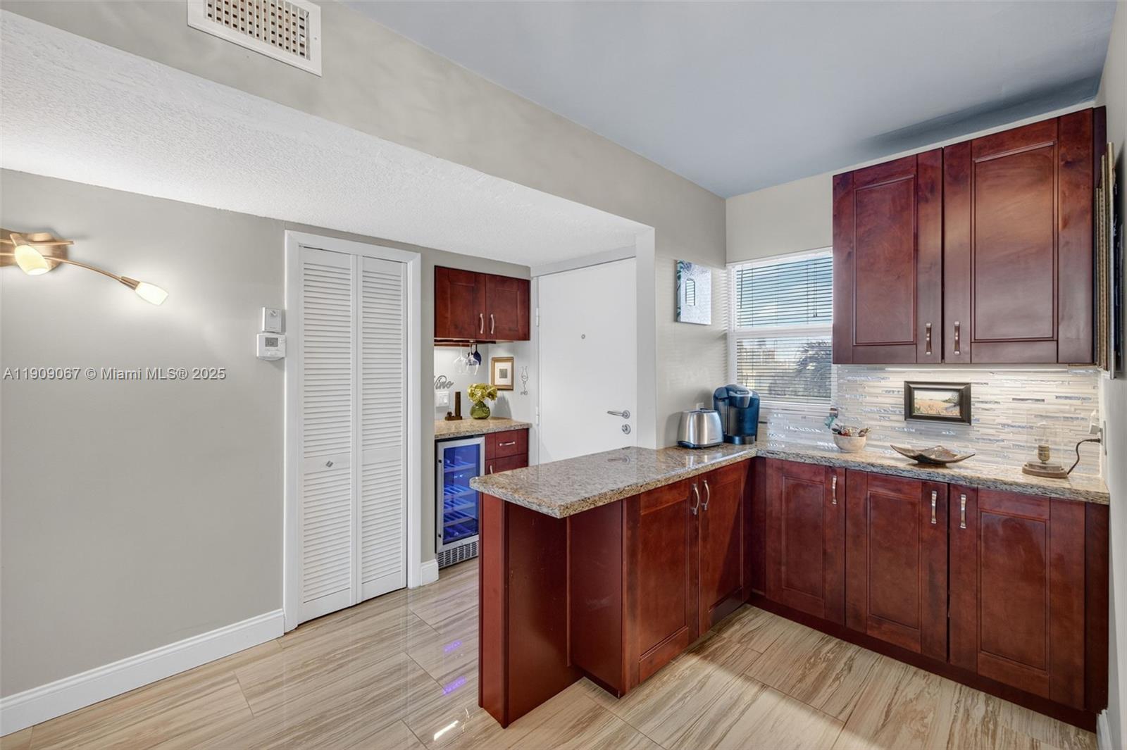 121 Golden Isles Drive, Unit 205 Hallandale Beach, FL 33009 - Photo 15 of 82 a kitchen with stainless steel appliances granite countertop wooden cabinets a sink and dishwasher